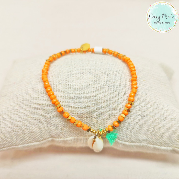 Bracelet élastique perle+acier orange/cowrie/pompons menthe